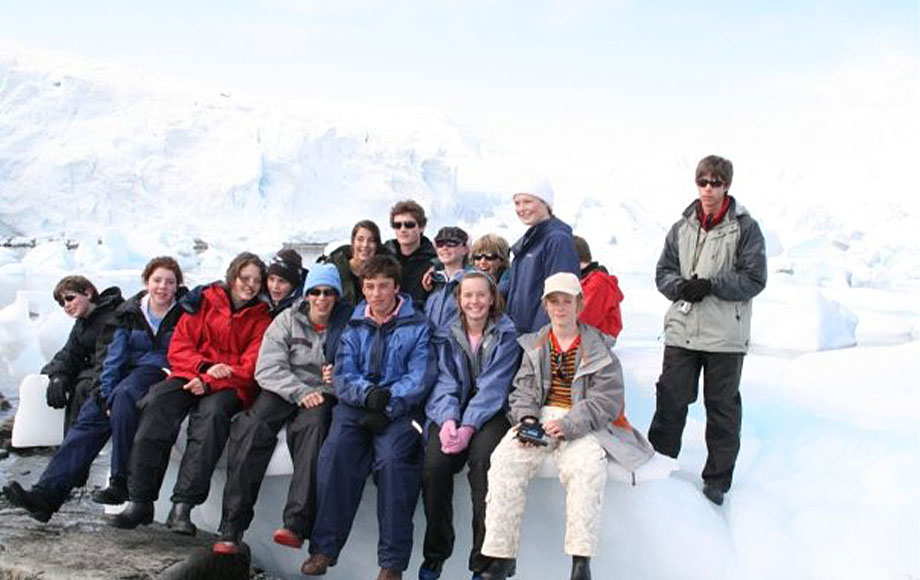 Jeremy in Antarctica sitting on Iceberg