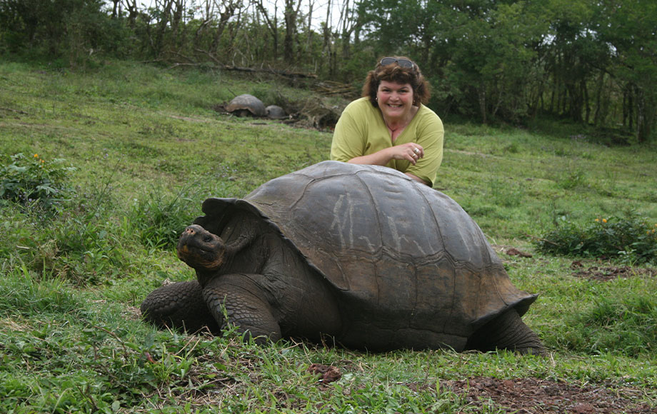 Annie in the Galapagos with a giant tortoise
