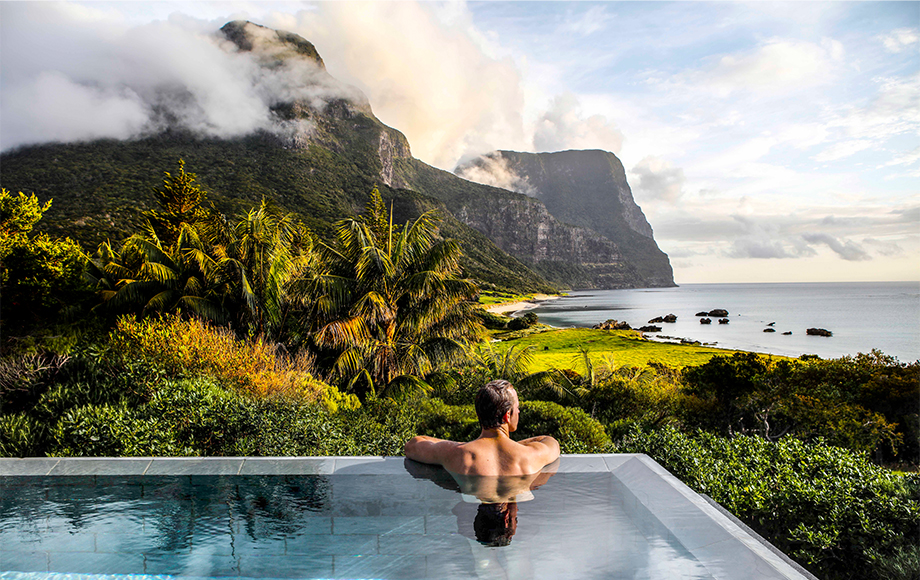 Man looking at Mount Gower from Capella Lodge