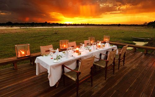 Dining at sunset at Zungulila Bushcamp on the Kapamba River